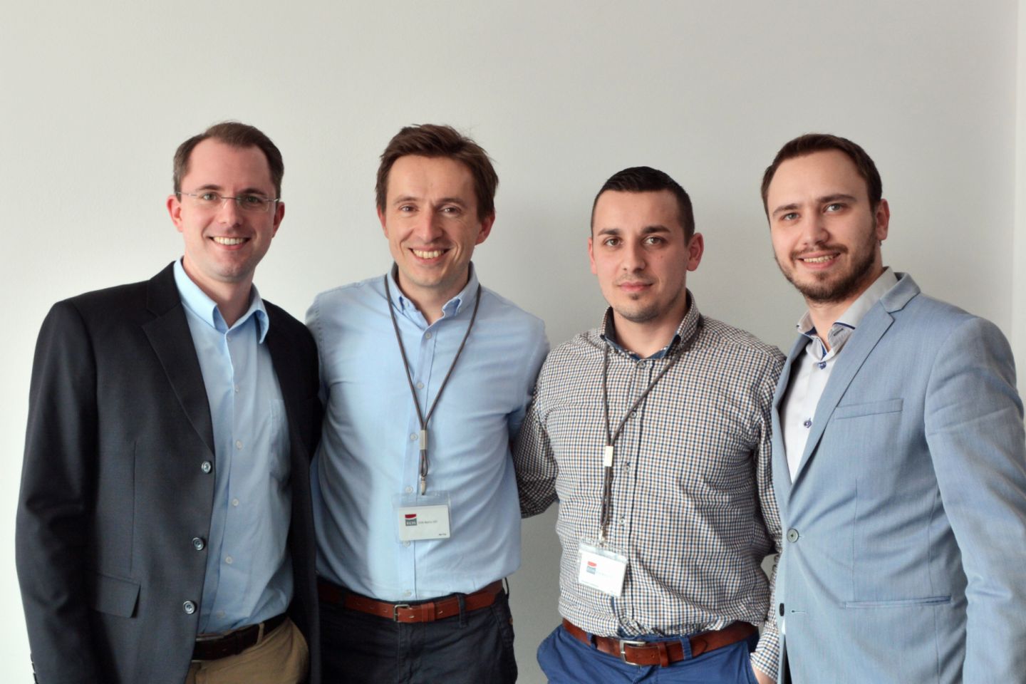 Four young project managers smile for the camera
