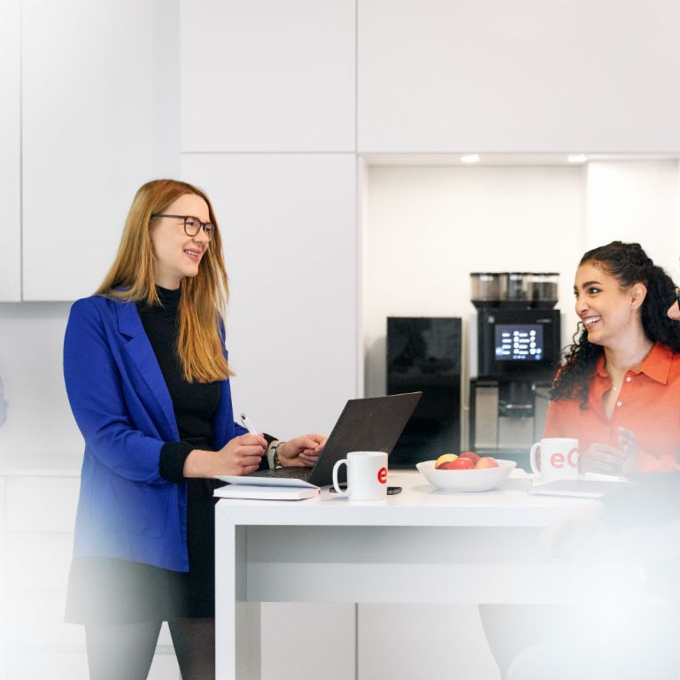 Three EOS colleagues working in kitchen having a cup of coffee 